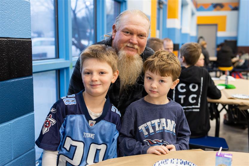 Trinity Elementary students eat donuts with dudes